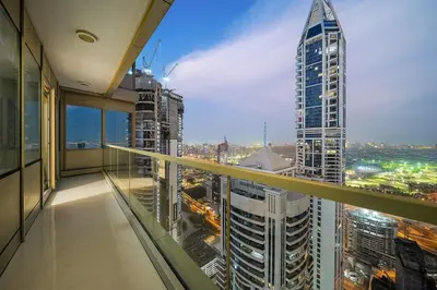 a view of a city from a balcony in a skyscraper at Elegant 2BR with Panoramic Marina View in Dubai
