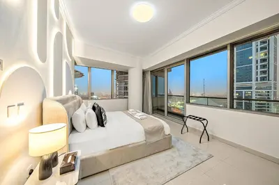 a bedroom with a bed and large windows at Elegant 2BR with Panoramic Marina View in Dubai