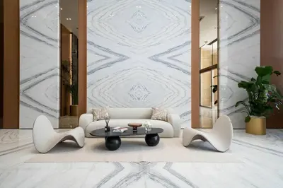 a living room with a white couch and a table at Luxury Studio in JVC Near Marina & Downtown in Dubai