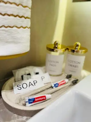 a bathroom with two candles and towels on a sink at Luxury Studio in JVC Near Marina & Downtown in Dubai