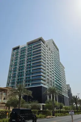 a truck parked in front of a large building at Luxury Studio in JVC Near Marina & Downtown in Dubai