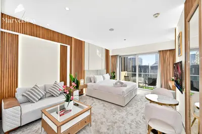 a living room with a couch and a table at MarvelStay - Connected to Mall & Metro - JW Marriott in Dubai