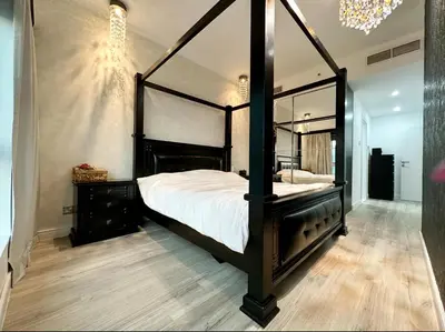 a bedroom with a black canopy bed with a mirror at JLT Luxury New 2BHK in Dubai