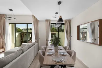 a living room with a couch and a table at Luxury 4BR Villa Free Malibu Beach Access in Dubai