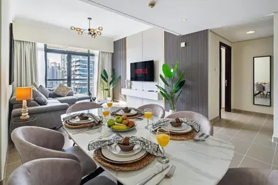 a living room with a dining table and chairs at Luxury JLT 1BR 2 Beds in Room Lakeview & Pool in Dubai