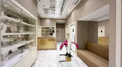 a room with glass shelves and a vase with flowers at Poolside Studio with Canal Views and Near Dubai Mall in Dubai