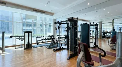 a gym with cardio equipment in a building at Poolside Studio with Canal Views and Near Dubai Mall in Dubai