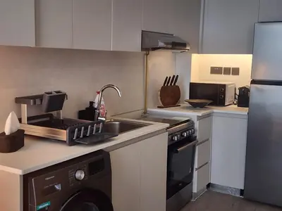 a kitchen with a sink and a stove and a dishwasher at City View Apartment very Close to Downtown and World Trade Center DIFC in Dubai