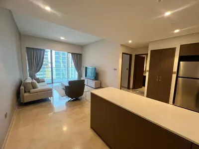 a kitchen and living room with a couch and a television at Grande in Dubai