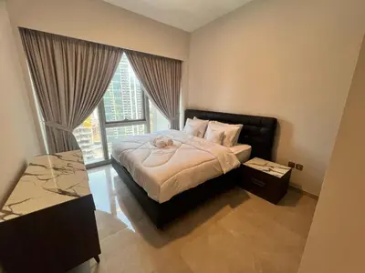 a bedroom with a bed and a large window at Grande in Dubai