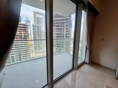a room with large windows with a view of a city at Grande in Dubai