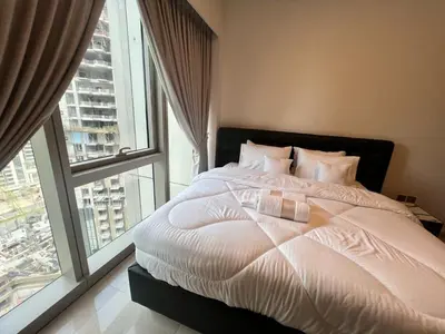 a bed in a bedroom with a large window at Grande in Dubai
