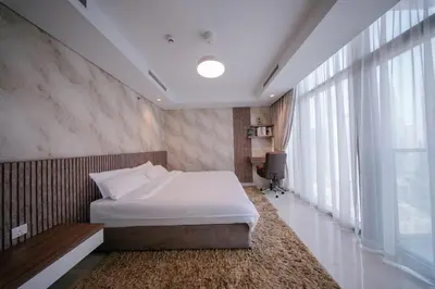 a bedroom with a bed and a large window at Amazing Burj Khalifa Views with Highest Infinity pool in Dubai