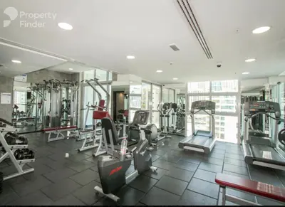 a gym with several tread machines in a room at Stylish 1-Bedroom Apartment in the Heart of Dubai Marina in Dubai