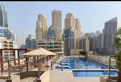 a swimming pool with a city skyline in the background at Stylish 1-Bedroom Apartment in the Heart of Dubai Marina in Dubai