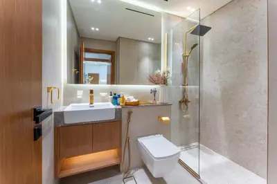 a bathroom with a toilet and a sink and a shower at Cozy Apartment Gym and Pool Heart of JVC in Dubai