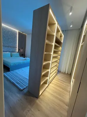 a room with a book shelf and a bed at Architect Designed house 2 BR with Private Pool in Dubai