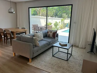 a living room with a couch and a table at Architect Designed house 2 BR with Private Pool in Dubai