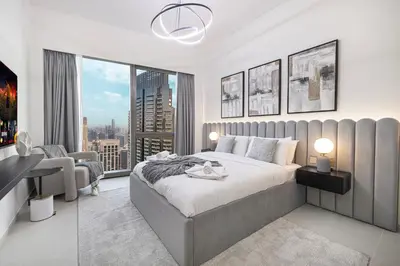 a bedroom with a large bed and a large window at Grande Altura Burj & Fountain view 57 floor in Dubai
