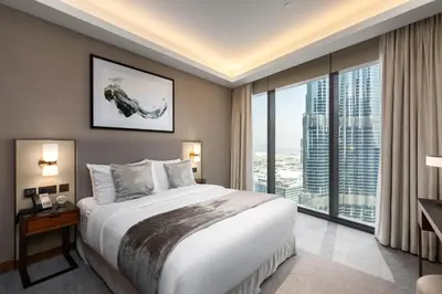 a bedroom with a large bed and a large window at Maison Privee - Fabulous Apt with Sensational Burj Khalifa Views in Dubai