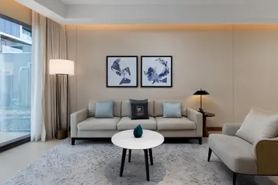 a living room with a couch and a table at Maison Privee - Fabulous Apt with Sensational Burj Khalifa Views in Dubai