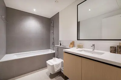 a bathroom with a tub and a toilet and a sink at Luxury 4BR Burj Khalifa Dubai Mall in Dubai
