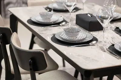 a table with plates and wine glasses on it at Luxury 4BR Burj Khalifa Dubai Mall in Dubai