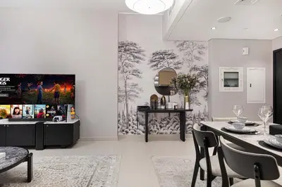 a living room with a tv and a dining room at Luxury 4BR Burj Khalifa Dubai Mall in Dubai