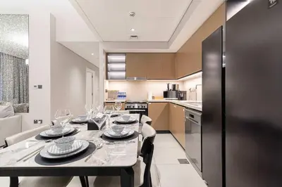 a kitchen with a table with wine glasses on it at Luxury 4BR Burj Khalifa Opera District in Dubai