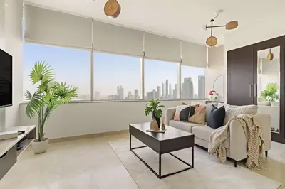 a living room with a couch and a large window at Silkhaus Modern Studio in Sky Gardens Tower DIFC in Dubai