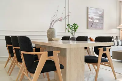 a dining room with a wooden table and chairs at Silkhaus Lavish 3BDR+Maid Room Imperial Avenue in Dubai