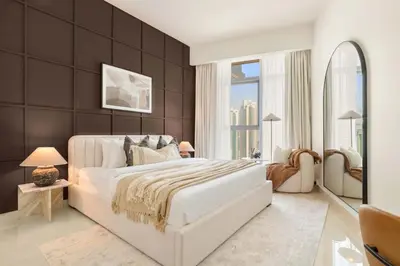 a bedroom with a large white bed and large windows at Silkhaus Lavish 3BDR+Maid Room Imperial Avenue in Dubai