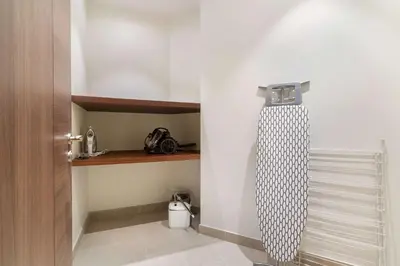 a room with a door with a towel hanging on the wall at Silkhaus Lavish 3BDR+Maid Room Imperial Avenue in Dubai