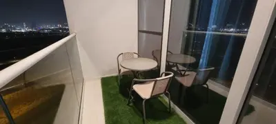 a room with three chairs and a table and a window at Carson Tower- A Damac Hills 1, Studio Apartment in Dubai
