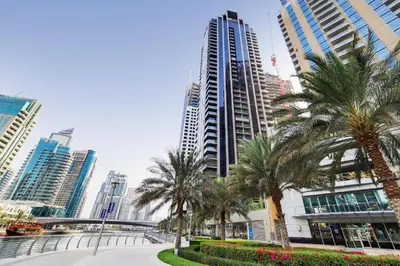 a city with palm trees and tall buildings at Modern 1 bedroom with Direct Marina Access in Dubai