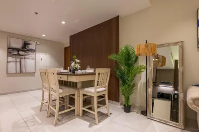 a dining room with a table and chairs and a mirror at Modern 1 bedroom with Direct Marina Access in Dubai