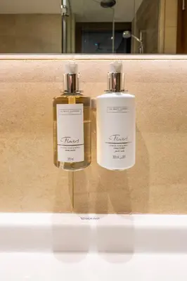 two bottles of soap sitting on a counter in a room at Modern 1 bedroom with Direct Marina Access in Dubai
