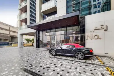 a black car parked in front of a building at Modern 1 bedroom with Direct Marina Access in Dubai