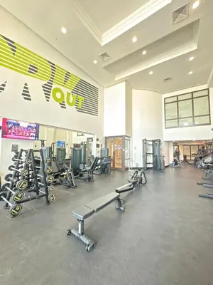 a gym with several rows of exercise bikes and treadmills at Souk Al Bahar Lavish 1-bedroom apartment with Burj Khalifa view at your doorstep by Norbu Holiday Homes in Dubai