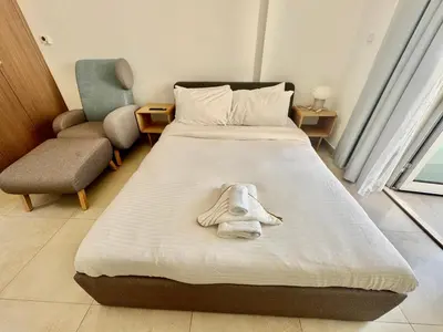 a hotel room with a bed with a towel on it at Homes2Retreat - Cozy Studio with Pool and Sauna in Al Furjan in Dubai