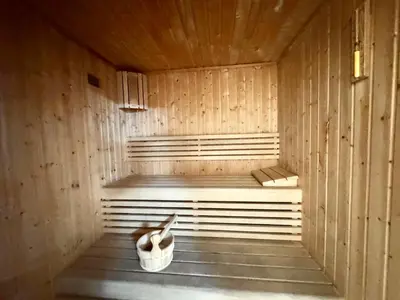 a sauna with a pair of shoes sitting in it at Homes2Retreat - Cozy Studio with Pool and Sauna in Al Furjan in Dubai