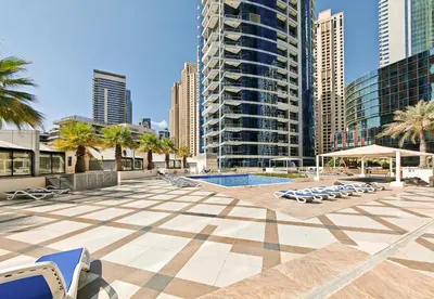 a pool in the middle of a city with buildings at New Modern Marina View Apartment in Bay Central in Dubai