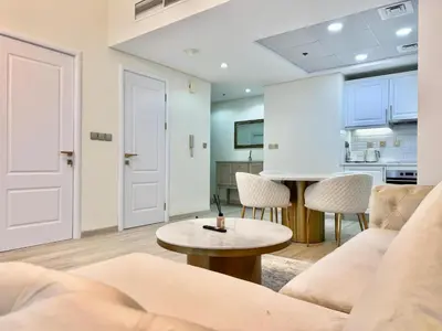 a living room with a couch and a table at New Modern Marina View Apartment in Bay Central in Dubai