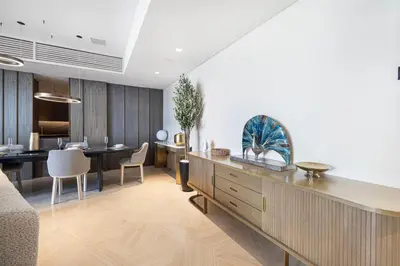 a living room with a kitchen and a dining room at Five Palm Jumeirah Luxury Apartment - 3BR in Dubai