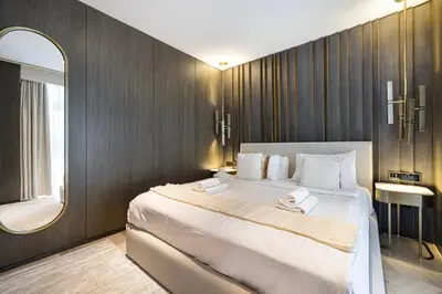 a bedroom with a large bed and a mirror at Five Palm Jumeirah Luxury Apartment - 3BR in Dubai