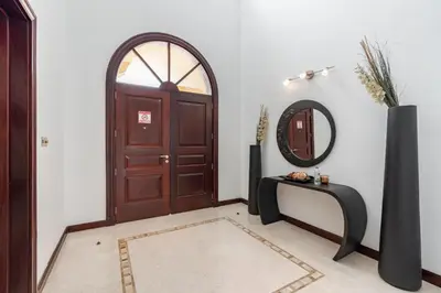 a hallway with a wooden door and a mirror at Palm Villa F, Palm Jumeirah - Mint Stay in Dubai