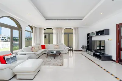 a living room with white furniture and a fireplace at Palm Villa F, Palm Jumeirah - Mint Stay in Dubai