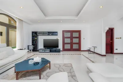 a living room with a couch and a tv at Palm Villa F, Palm Jumeirah - Mint Stay in Dubai