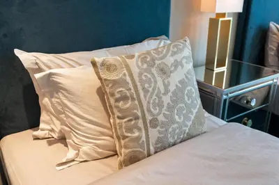 a bed with two pillows on it with at BLVD - Direct Marina Walk - Eye of Dubai Fireworks - Iconic Marina Views with Rooftop Pool in Dubai