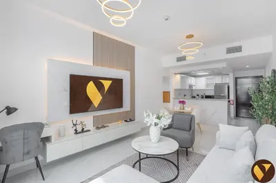 a living room with a couch and a table at Vogue Marina Diamond Near JBR Beach and Marina Mall, One Bedroom Apartment with Balcony and City View, Access to all Amenities, Walkable to Sobha Realty Metro Station and Bus Stop in Dubai
